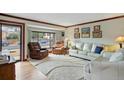 Bright living room with hardwood floors, white couches and large windows at 2140 S Youngfield St, Lakewood, CO 80228