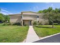 Charming exterior view of building 710 with well-maintained lawn and landscaping at 710 S Clinton St # 1A, Denver, CO 80247