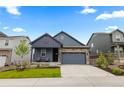 Well-maintained two story home with stone accents and a cozy front porch seating area at 8132 Mt Harvard Rd, Littleton, CO 80125