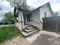 A quaint home features a covered porch with weathered steps leading to the entrance at 2771 W 1St Ave, Denver, CO 80219