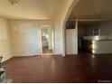 A spacious living room with hardwood floors and an open layout leading to the kitchen at 2771 W 1St Ave, Denver, CO 80219