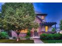 Beautiful two-story home with brick facade, a lovely porch, and a lush green tree in the front yard at 237 Dayton St, Denver, CO 80230