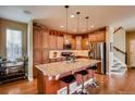 Spacious kitchen featuring a large island with barstool seating, stainless steel appliances, and ample cabinet space at 237 Dayton St, Denver, CO 80230