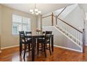 Bright dining room with modern chandelier and easy access to the staircase at 2948 Open Sky Way, Castle Rock, CO 80109