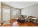 Comfortable living room features hardwood floors, a couch, and natural light at 2948 Open Sky Way, Castle Rock, CO 80109