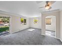 Bright open-plan living space with gray carpet and natural light at 1941 S Dexter St, Denver, CO 80222