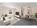 Bright living room with neutral tones, gray carpet, and comfortable seating at 1941 S Dexter St, Denver, CO 80222