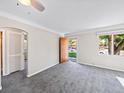 Bright and spacious living room featuring neutral walls, soft carpet, and ample natural light at 1941 S Dexter St, Denver, CO 80222