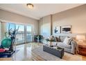 Bright living room with hardwood floors and access to a balcony at 1950 N Logan St # 807, Denver, CO 80203