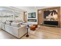 Cozy living room with a modern fireplace, sleek furniture, and stylish accent wall at 4408 Riviera Ct, Aurora, CO 80019