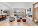 Spacious living room with hardwood floors, a modern fireplace, and an open layout at 4408 Riviera Ct, Aurora, CO 80019