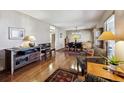 Spacious living room with hardwood floors flowing into the dining area, perfect for entertaining at 1479 S Jasper St, Aurora, CO 80017