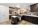 Modern kitchen with stainless steel appliances and a center island at 10601 W 78Th Ave, Arvada, CO 80005