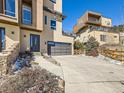 Attractive home exterior with a two-car garage, modern door, and well-maintained landscaping at 28665 Tepees Way, Evergreen, CO 80439