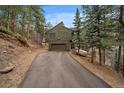 Charming home with a two-car garage nestled in a serene, wooded setting at 3065 Piney Ridge Rd, Evergreen, CO 80439