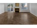 Living room with hardwood floors and brick fireplace at 1256 S Zeno Cir # E, Aurora, CO 80017