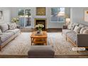 Staged living room with fireplace, lots of light and comfortable seating at 1256 S Zeno Cir # E, Aurora, CO 80017