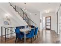 Elegant dining area featuring hardwood floors, a modern chandelier, and stylish blue chairs at 1373 S Garfield St, Denver, CO 80210