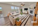 Bright living room featuring neutral furniture, fireplace, and large windows offering scenic views at 14880 Chicago St, Parker, CO 80134