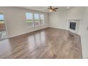 Spacious living room with beautiful hardwood floors, ample natural light, and a cozy fireplace at 14880 Chicago St, Parker, CO 80134