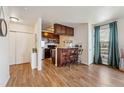 Open floorplan with hardwood floors and a modern kitchen with bar seating at 320 S Ames St # 8, Lakewood, CO 80226