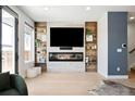 Living room with a stunning fireplace and built-in shelving at 1636 Winona Ct, Denver, CO 80204