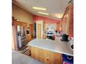 Bright kitchen featuring stainless steel appliances, tile floors, and abundant cabinet space at 16659 County Road 4, Brighton, CO 80603