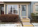 Charming townhome front entrance featuring yellow steps and house number above the door at 14272 E Hawaii Cir # B, Aurora, CO 80012