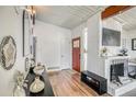 Bright foyer features hardwood floors, red front door, and a decorative console table with stylish accents at 450 Yukon St, Lakewood, CO 80226