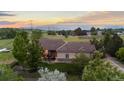 Charming one-story home boasts a beautiful yard, mature trees and mountain views in the distance at 5653 Yank St, Arvada, CO 80002