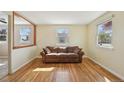 Bright living room featuring hardwood floors, natural light, and a comfortable seating area at 6819 Reno Dr, Arvada, CO 80002