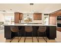 Bright kitchen features a large island, granite countertops, and modern lighting at 6844 W 69Th Pl, Arvada, CO 80003