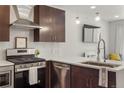 A modern kitchen features stainless steel appliances, white subway tiles, and pristine white countertops at 1898 S Bannock St # 510, Denver, CO 80223