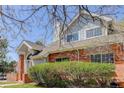 Charming two-story home featuring brick accents, landscaped yard and light blue siding at 3951 S Carson St # D, Aurora, CO 80014