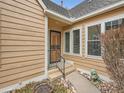 Close-up view of the home's front entrance, featuring a security door and a small landscaped garden at 10000 E Yale Ave # 58, Denver, CO 80231