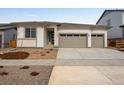 Attractive one-story house with a three-car garage, complemented by stone and siding accents at 24741 E 33Rd Dr, Aurora, CO 80019