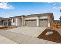 Inviting one-level home features a spacious three-car garage and a well-kept front yard at 24741 E 33Rd Dr, Aurora, CO 80019