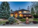Elegant brick and stucco two-story home boasts professional landscaping and a welcoming entrance with manicured bushes at 2464 Ginny Way, Lafayette, CO 80026