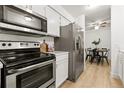 Modern kitchen with stainless steel appliances and marble countertops at 14652 E 2Nd Ave # 202D, Aurora, CO 80011