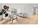 Living room features hardwood floors, fireplace, and access to balcony at 14652 E 2Nd Ave # 202D, Aurora, CO 80011