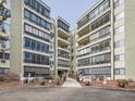 Multi-story apartment building with balconies, large windows, and landscaped entrance showcasing modern architecture at 13961 E Marina Dr # 205, Aurora, CO 80014