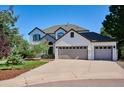Stunning two-story home featuring a three-car garage and a well-manicured front yard at 327 Ingleton Ct, Castle Pines, CO 80108