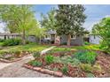 Charming single-story home with a landscaped front yard and a welcoming red front door at 1343 Gay St, Longmont, CO 80501