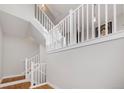 Bright, open staircase featuring white railings, hardwood floors, and natural light at 5471 W 97Th Pl # F, Westminster, CO 80020