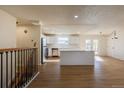 Open-concept living room flows into the updated kitchen with stainless appliances and a large center island at 1266 S Telluride St, Aurora, CO 80017