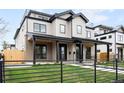 Charming two-story home with a well-manicured lawn, black metal roof, and a welcoming front porch at 2520 S Cherokee St, Denver, CO 80223