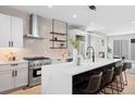 Modern kitchen with a large island, stainless steel appliances, and sleek white cabinetry at 2520 S Cherokee St, Denver, CO 80223