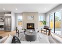 Sun-filled living room features a tiled fireplace and open layout perfect for modern living at 2520 S Cherokee St, Denver, CO 80223