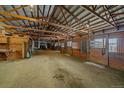 Spacious barn with multiple horse stalls and tack area at 7295 Sunset Ave, Elizabeth, CO 80107