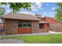 Lovely brick home featuring manicured landscaping and a charming exterior in a peaceful setting at 11254 E Colorado Dr, Aurora, CO 80012